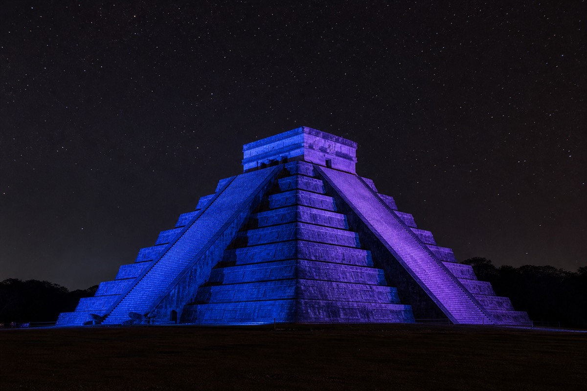 El Castillo lit up in color during the evening light and sound show at Chichen Itza