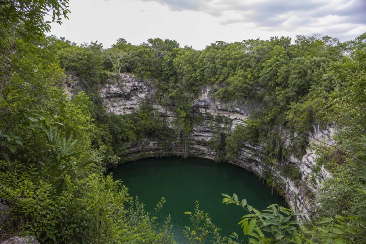 The wide green waters of the Sacred Cenote at Chichen Itza